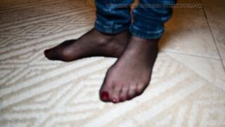 Feet in black stockings and jeans