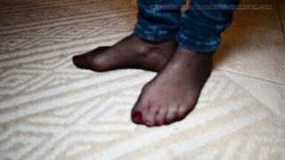 Feet in black stockings and jeans