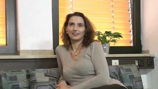 Happy and smiling sexy brunette german milf gets up and dildoes her pussy while she strokes her small tits - 2 image